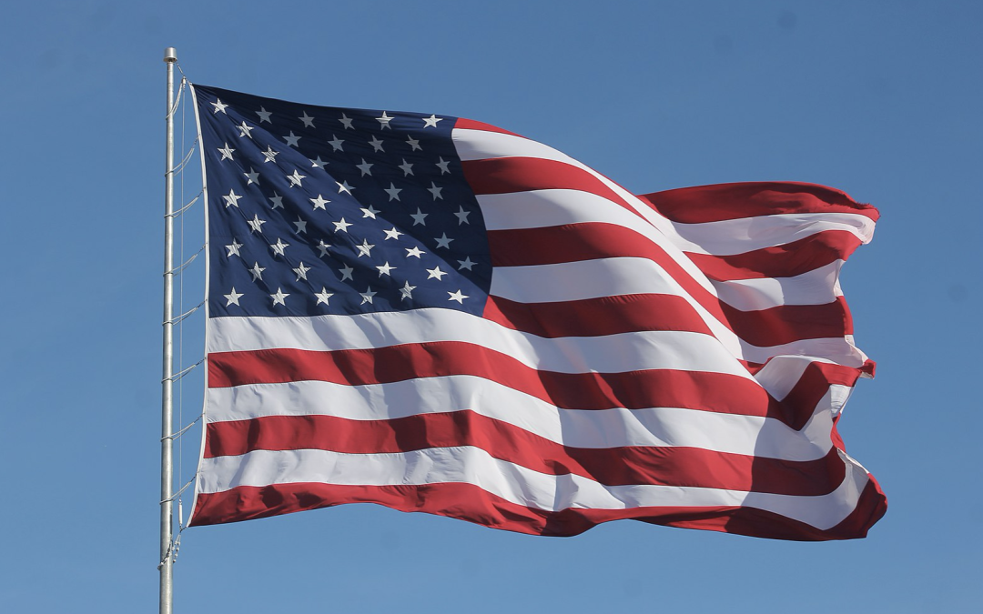 American flag waving against a blue sky